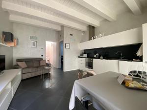 a kitchen and living room with a couch and a table at CasaMartaNavigli in Milan