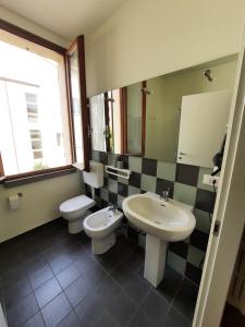 a bathroom with a sink and a toilet and a mirror at r&b del vicolo in Cesena +7 photos