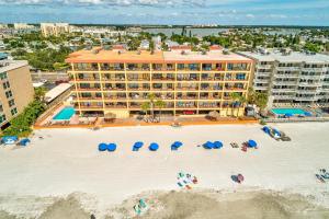 an aerial view of a resort with a beach with umbrellas at Las Brisas 202 in St. Pete Beach