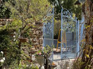 a blue gate in a garden with flowers at Yellow Aloe in Clanwilliam