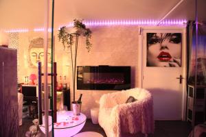 a living room with a woman with red lipstick at Spa de la Lune - Private love room suite with terrace and view - Air Conditioned- Double jacuzzi - Sauna - King size bed - Free WIFI - Free parking - Free breakfast - Close to CDG airport and to the North of Paris in Clichy-sous-Bois