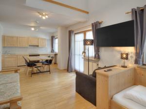 a living room with a couch and a table at Center Rooms & Apartments in Mayrhofen