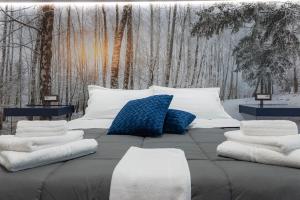 a large bed with pillows on top of it at LN ETNA HOUSE-villa ad uso esclusivo in Pedara