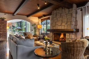 a living room with a couch and a fireplace at WE Hotel in Campos do Jordão