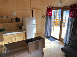 a kitchen with a refrigerator and a counter top at Camping, Hôtel De Plein Air Les Cariamas in Chateauroux-les-Alpes