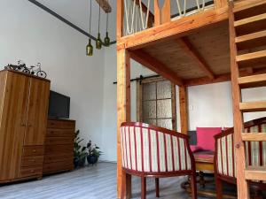 a dining room with a table and a television at Szeged-Vár in Szeged