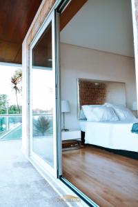 a bedroom with a bed and a sliding glass door at Casa Lima Braga in Braga