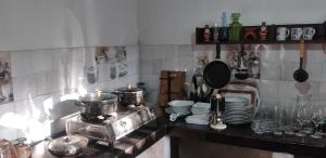 a kitchen with two pots and pans on a stove at Kuma Beach side Villa in Wadduwa