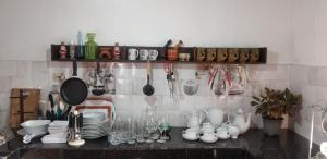 a kitchen with a counter with dishes and utensils at Kuma Beach side Villa in Wadduwa