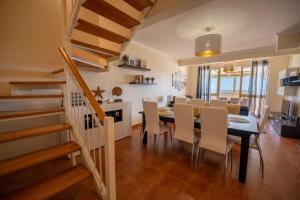 a dining room and kitchen with a table and chairs at Vista Mar in Porto Santo