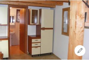a kitchen with a tall refrigerator and a counter at Antico Borgo in Casole Bruzio