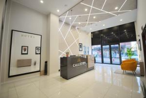 a lobby of a hotel with a reception desk in it at Hotel Callisto in Pristina