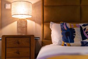 a bedroom with a bed and a lamp on a night stand at Palm Beach in Ajaccio