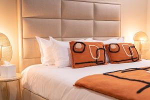 a bedroom with a bed with two pillows on it at Palm Beach in Ajaccio