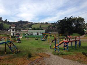 a group of children playing in a playground at Mantagua Village in Concón