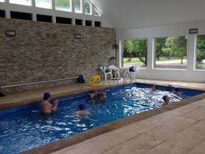 a group of people in a swimming pool at Mantagua Village in Concón