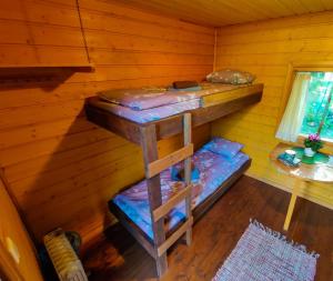 a room with two bunk beds in a cabin at Atsikivi Puhketalu in Häädemeeste