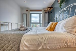 a bedroom with a large bed and a window at Cute 2 bed flat in the heart of Derby By 20Property Stays Short Lets & Serviced Accommodation in Derby