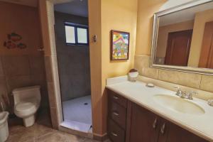 a bathroom with a sink and a toilet and a shower at Suite Granada 131 Gran Pacifica Resort in San Diego