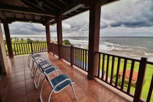 a porch with chairs and a view of the ocean at Suite Granada 131 Gran Pacifica Resort in San Diego