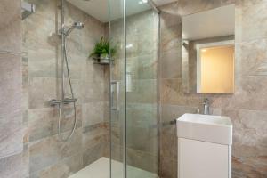 a bathroom with a glass shower and a sink at Crown Street in Bury Saint Edmunds