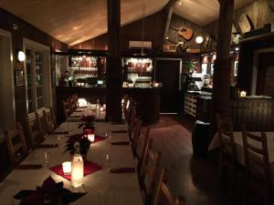 a dining room with a long table with candles at Garsnes Brygge in Sjøvegan