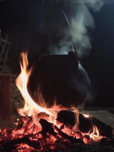 una persona está agitando una olla sobre un fuego en Le Sommet Naturel, en Chefchaouen