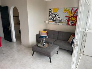 a living room with a couch and a table at MEERBLICK BEACH-APARTMENT Monte Rojo in San Agustin +41 photos