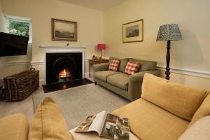 a living room with a couch and a fireplace at The White House in Duns