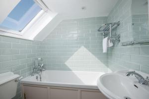a bathroom with a sink and a bath tub at The White House in Duns +15 photos