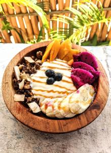 a plate of food on a wooden plate at Sarinah Beach - Bistro & Bungalow in Nusa Penida