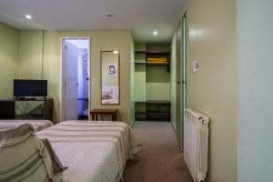 Ένα ή περισσότερα κρεβάτια σε δωμάτιο στο Hotel Arte del Rey