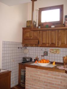 a kitchen with a plate of oranges on a counter at Mimi House in Lido di Camaiore