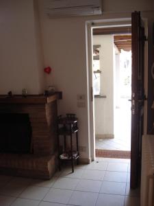 a living room with a fireplace and an open door at Mimi House in Lido di Camaiore