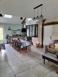 a large living room with a table and chairs at Le clos des augers. Chambre Descartes in Azay-sur-Cher