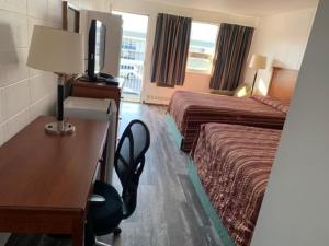 Postel nebo postele na pokoji v ubytování Raven Motor Inn
