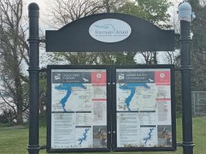 a sign in a park with a map of the world at Lakeview farm in Castletown