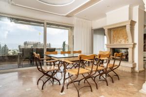 a dining room with a table and chairs and a fireplace at King David Penthouse with private pool in Jerusalem
