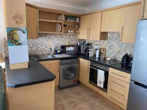 a kitchen with a refrigerator and a dishwasher at ChezVous in Swords