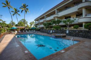 a swimming pool in front of a hotel at Holualoa Bay Villas#105 in Kailua-Kona