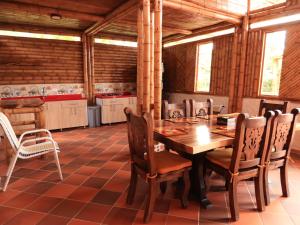 a dining room with a wooden table and chairs at Villa Jardines de la Monarca in Rivera