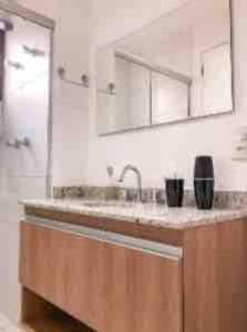 a kitchen counter with a sink and a shower at 92 New studio next Paulista Av, fast wifi and balcony in Sao Paulo