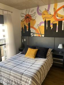a bedroom with a bed with a mural on the wall at 92 New studio next Paulista Av, fast wifi and balcony in Sao Paulo