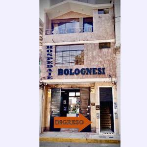 a building with an orange sign in front of it at Hospedaje bolognesi in Piura