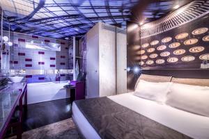 a hotel room with a bed and a bathroom at Apostrophe Hôtel in Paris