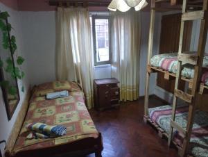 a bedroom with two bunk beds and a window at HOSTEL ATG in Ciudad Lujan de Cuyo