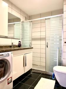 a bathroom with a washer and a sink and a washing machine at dream house in istanbul in Istanbul