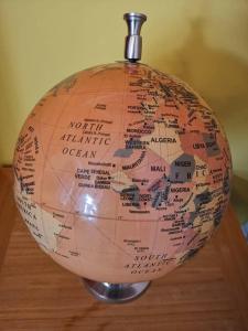 a globe sitting on top of a wooden table at The Superhost - 4 BR House in Sunderland
