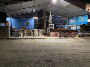 a building with tables and chairs and a bar at Mi Gran Victoria in Manta