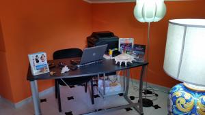a desk with a laptop computer on top of it at Villa Carmelas in Taormina +23 photos